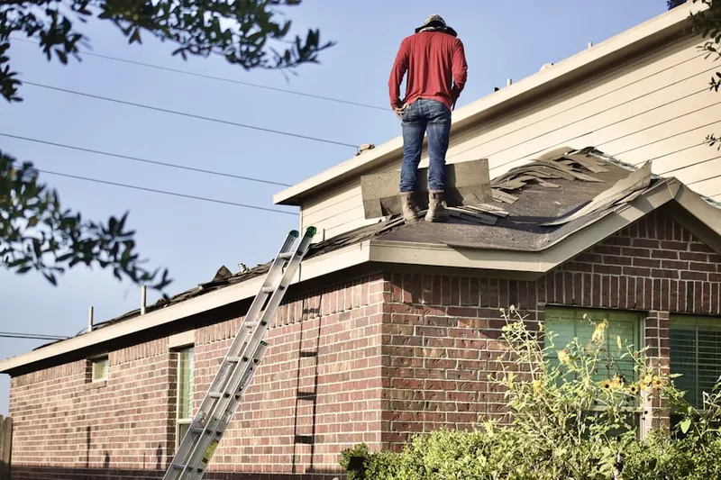 Professional roofer working on a residential roof in Minoa